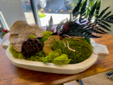 Decorative arrangement with moss, leaves, and natural elements on a wooden surface